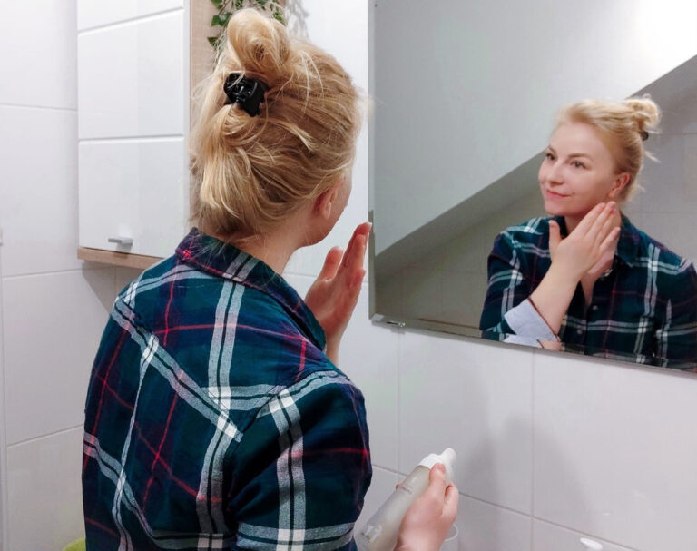 Frau im Badezimmer die die RINGANA Produkte anwendet.